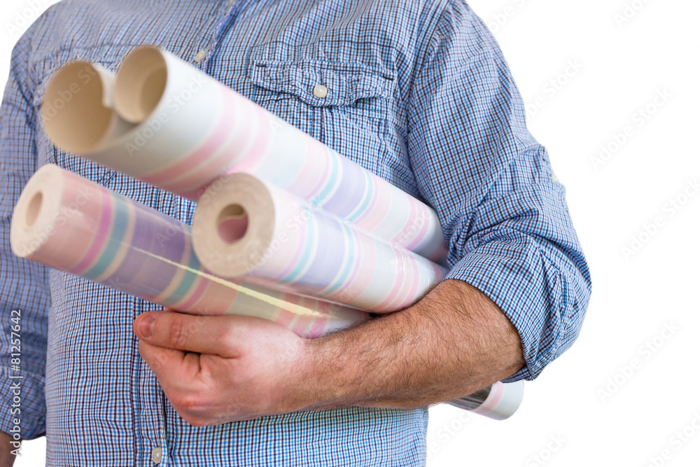 Handyman carrying rolls of wallpaper