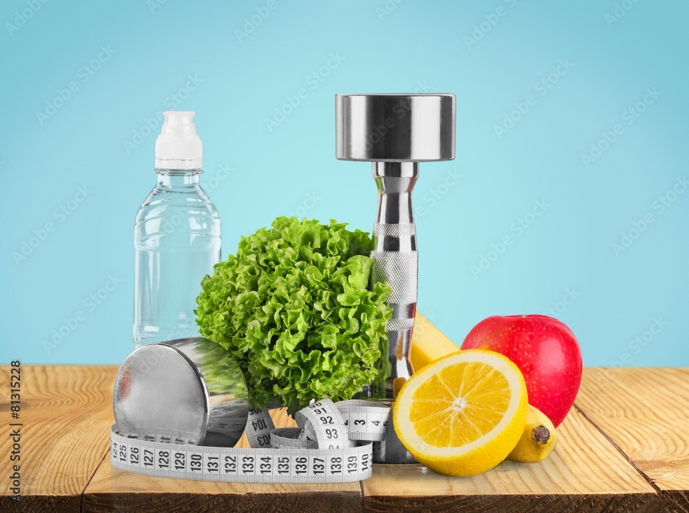 Gym. Fitness equipment with fruits and bottle of energy drink