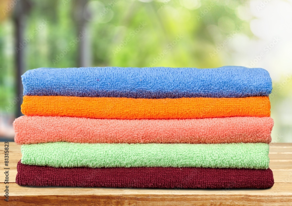 Towel. Five stacked, multicolored bath towels isolated on white