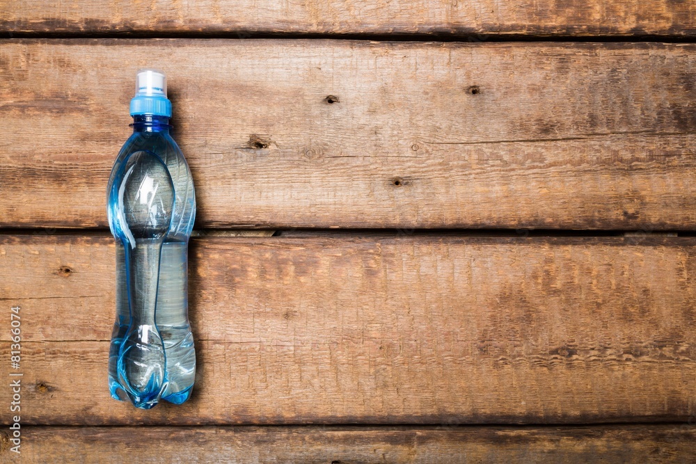 Water. Plastic water bottle on the wooden table