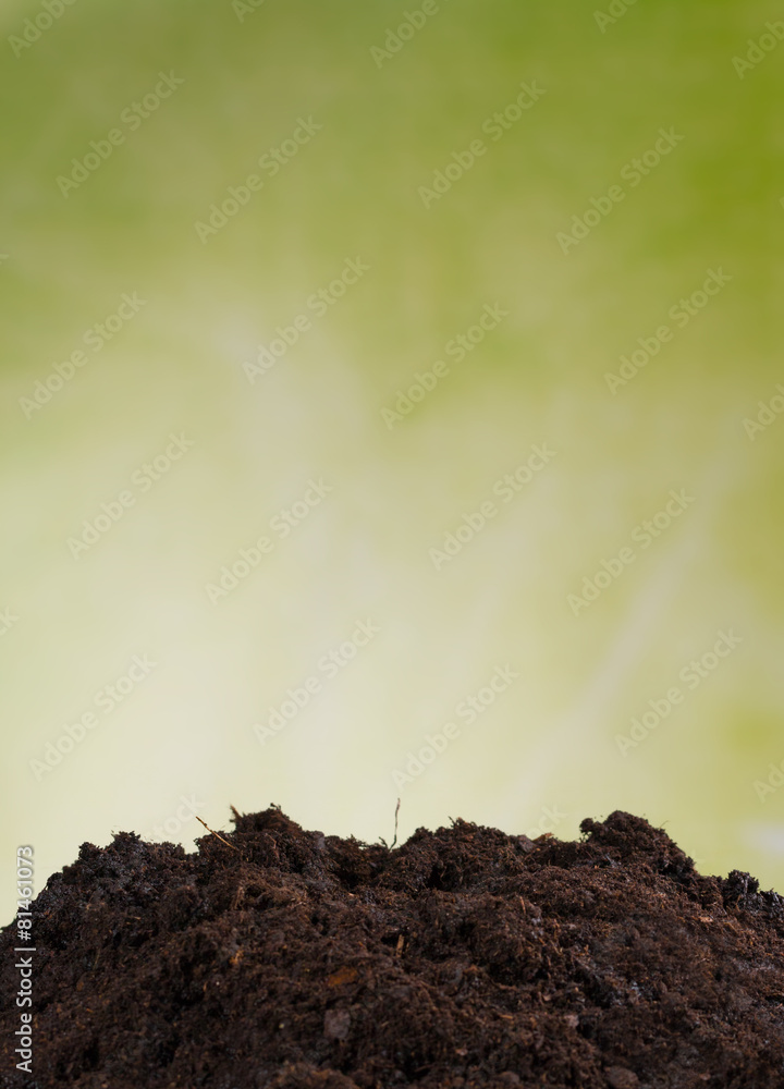 Pile of soil with green background