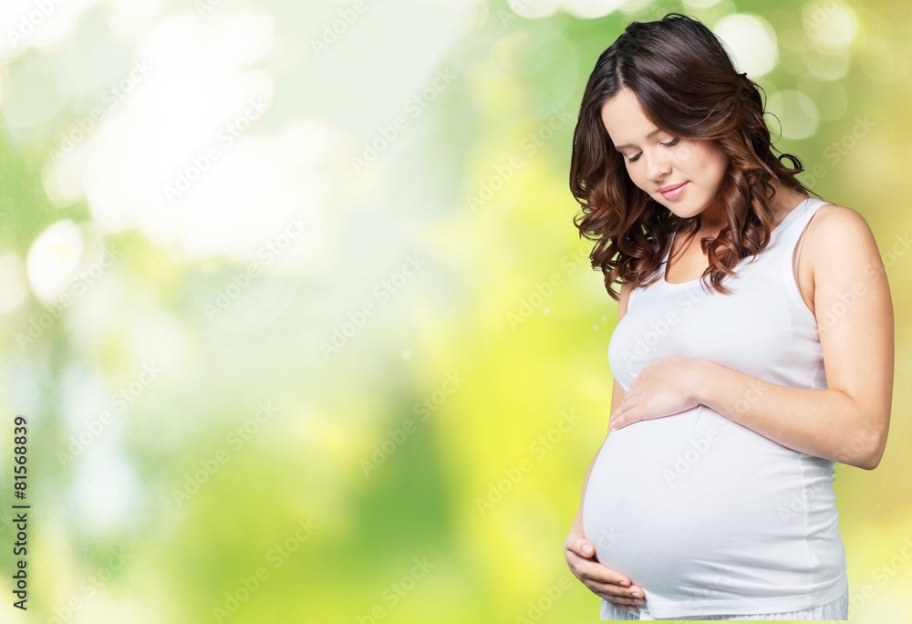 Adorable. Portrait of adorable pregnant woman in white