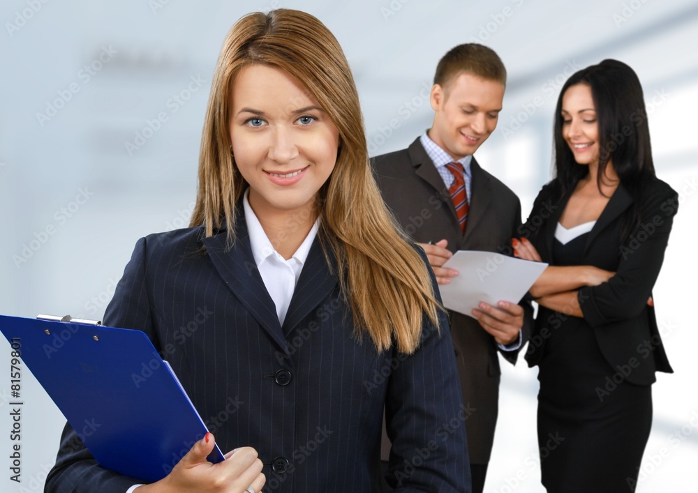 Business. Happy businesswoman with colleagues in the background