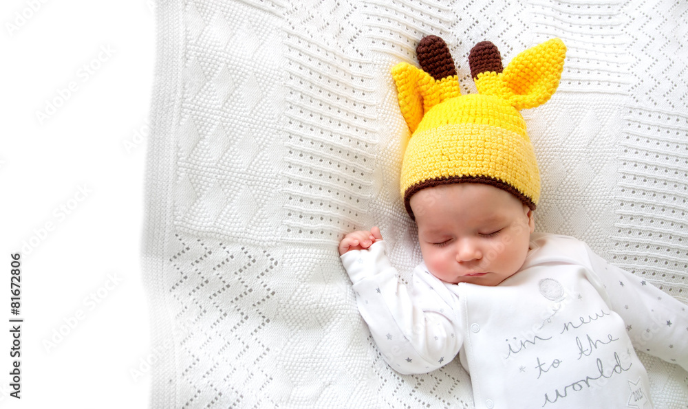 Baby sleeping in giraffe hat