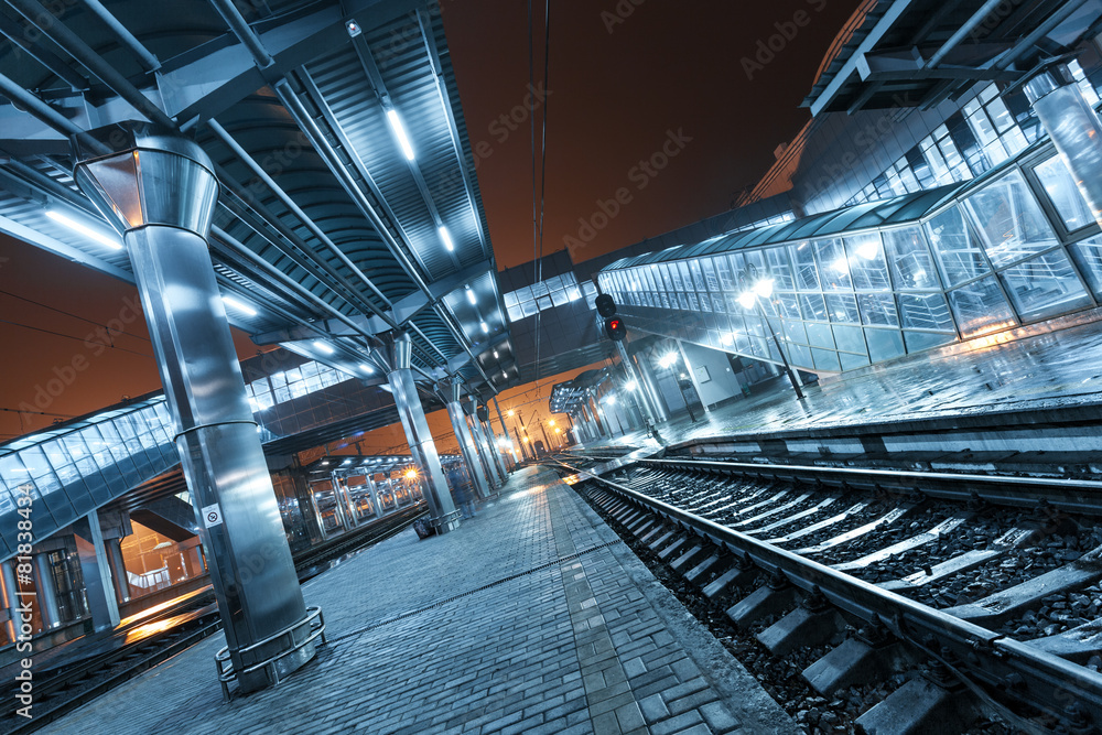 Railway station at night. Train platform in fog. Railroad