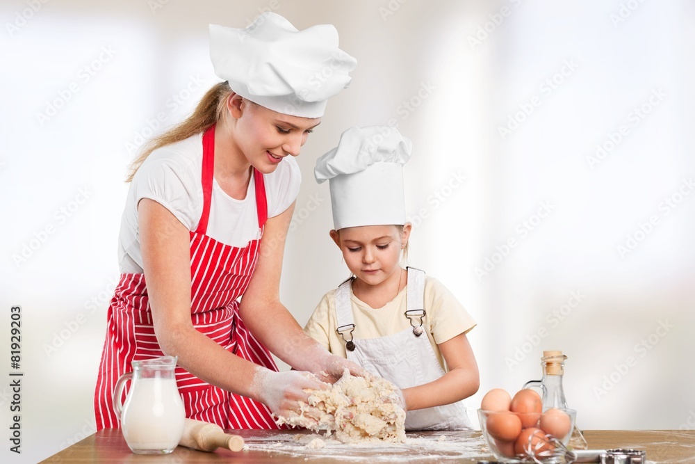 Baby. Baby girl with her mother rolled out the dough cook, bake