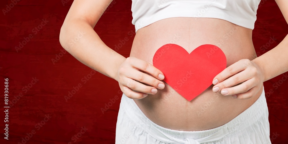 Love. Pregnant mother showing her belly and holding a gift