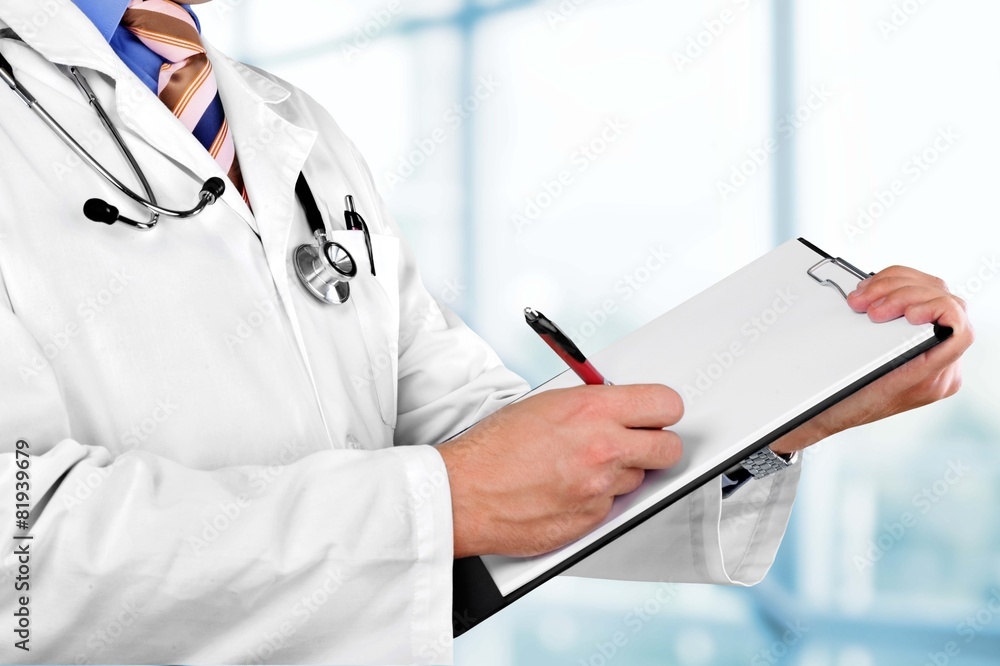 Doctor. Filling out medical document