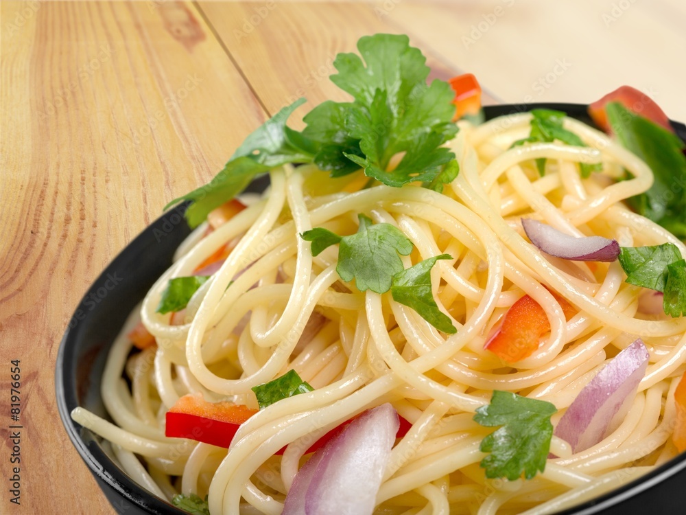 Spaghetti. Pasta in a white bowl with tomato sauce and fresh