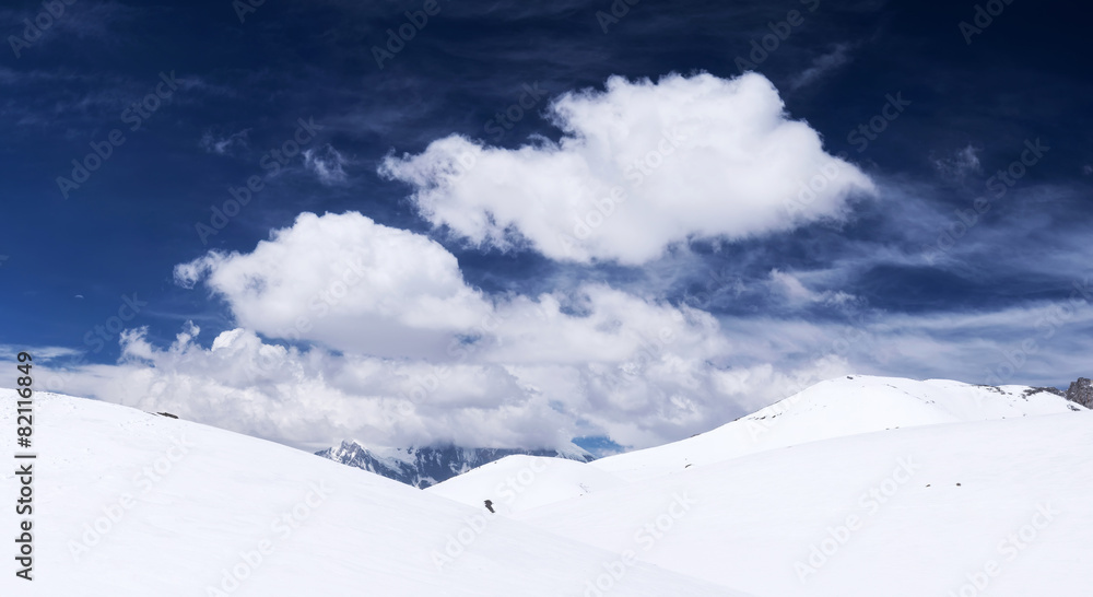 Hills with snow and clouds. Beautiful winter landscape