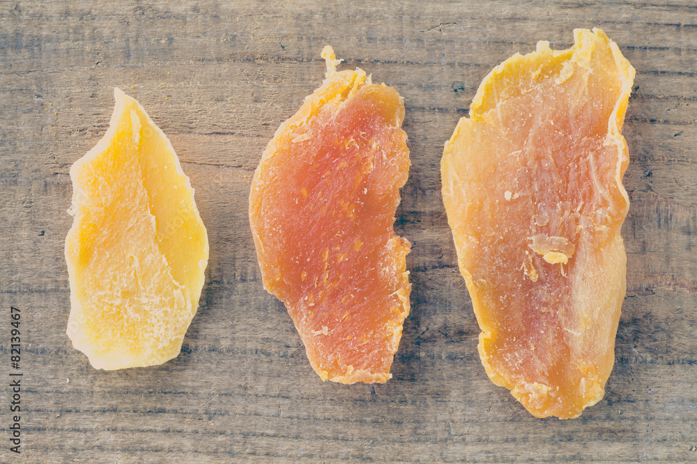 Piece of Dehydrated mango on wood table background