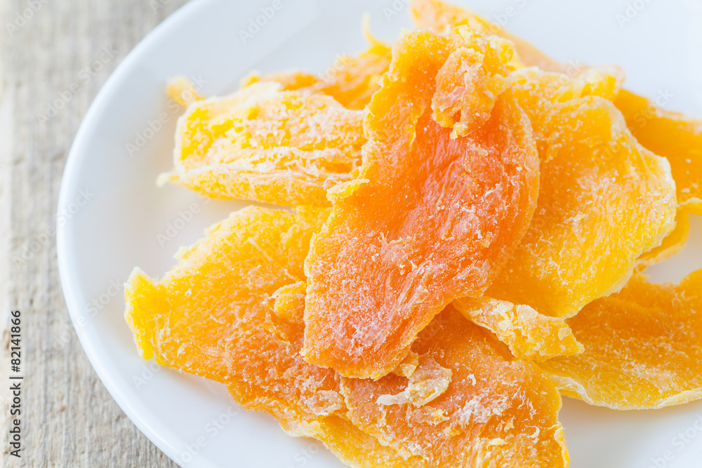 Piece of Dehydrated mango on white ceramic dish