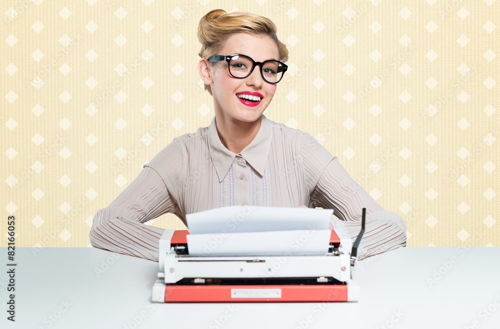 Woman. Beautiful woman writes with a typewriter