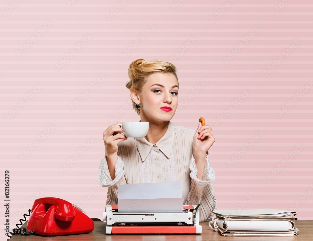 Secretary. Smiling business woman eating a cookie, break from