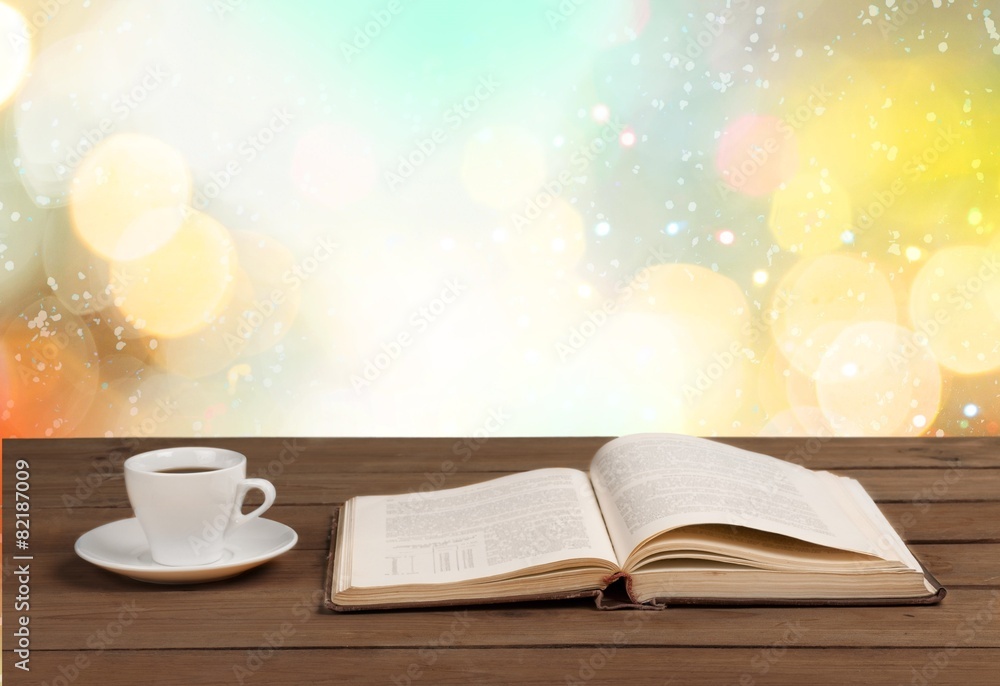 Book. Cup of coffee and a book on a wooden table