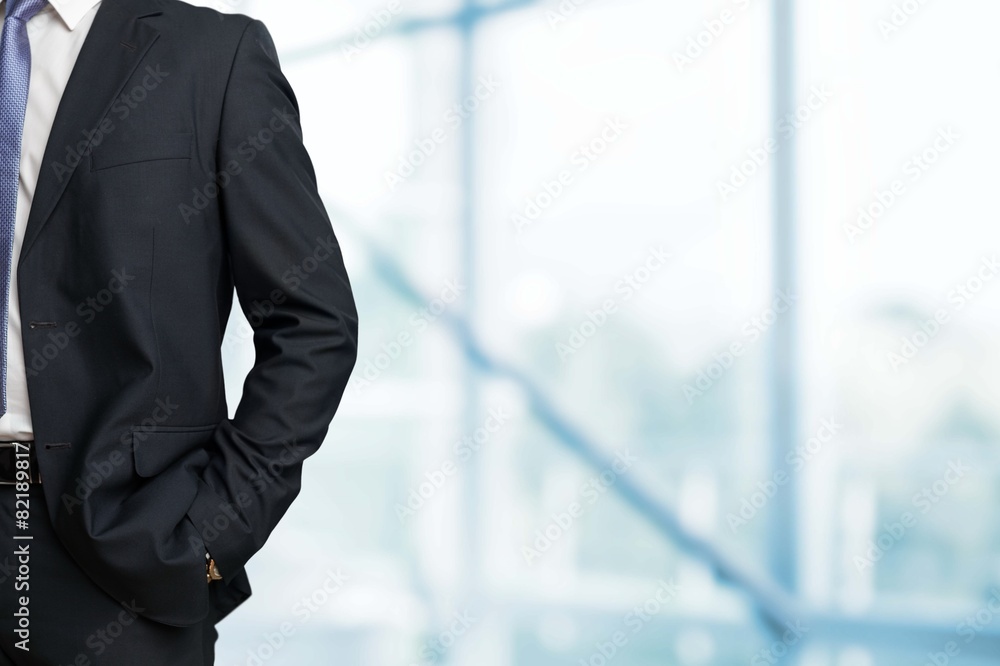 Business. Man in suit on a concrete wall background