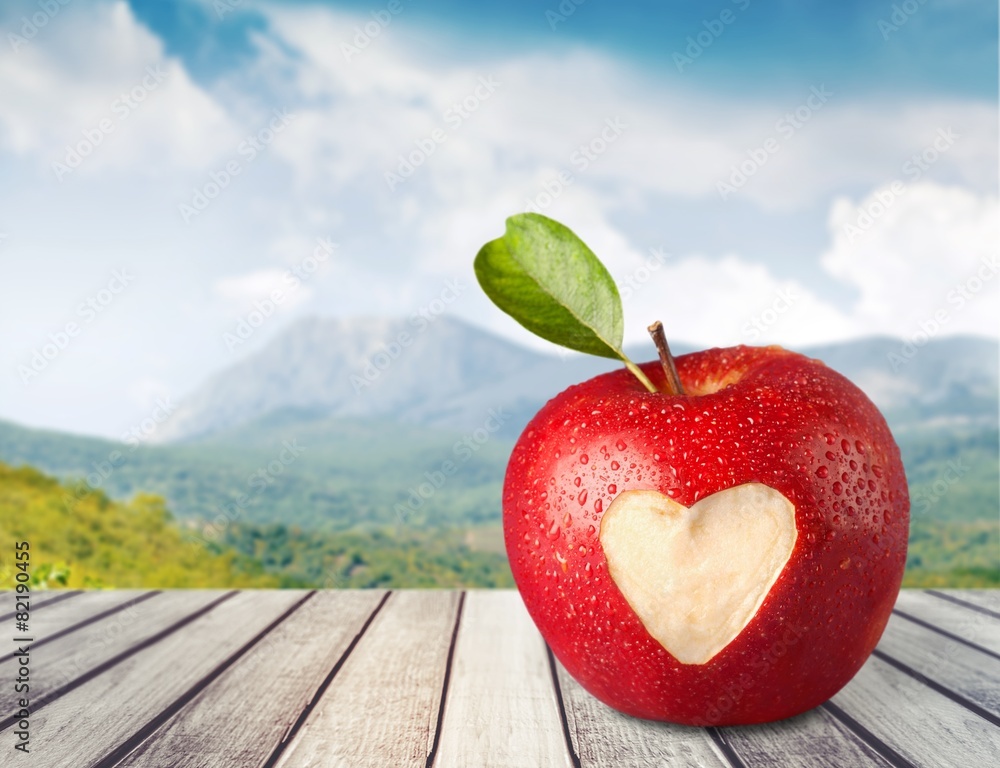 Heart Shape. Fresh red apple with heart symbol and leaf