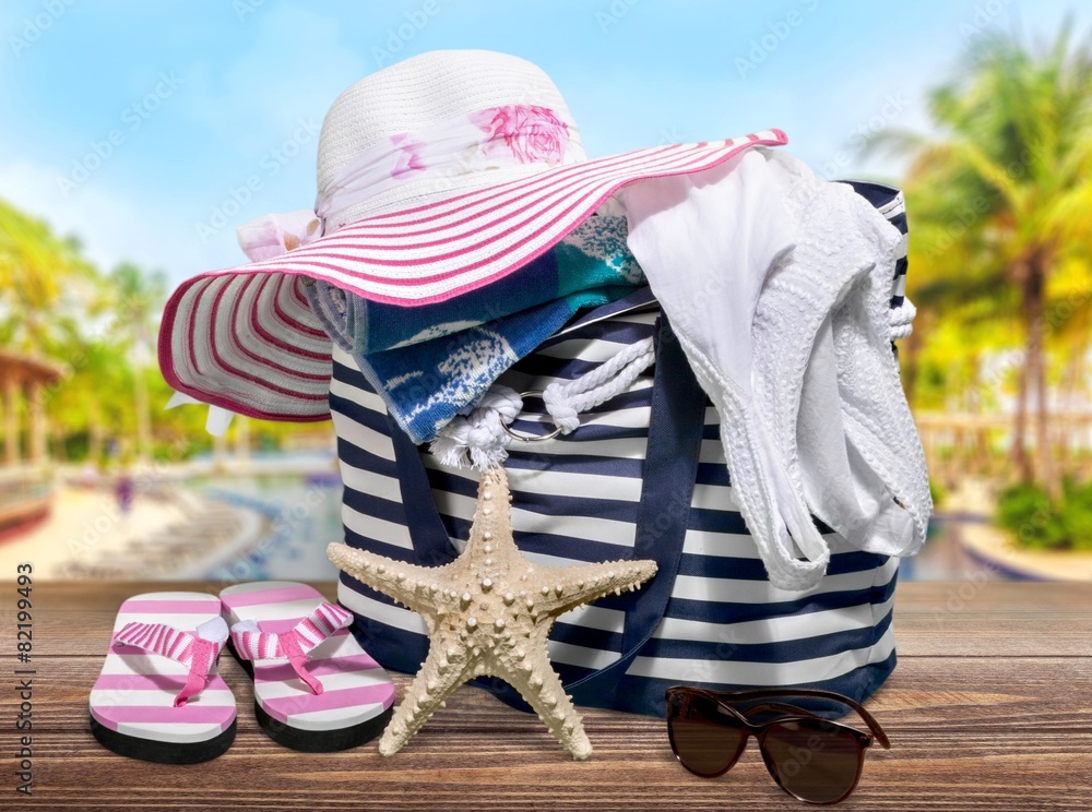 Beach. Art Straw hat, bag, sun glasses and flip flops on a