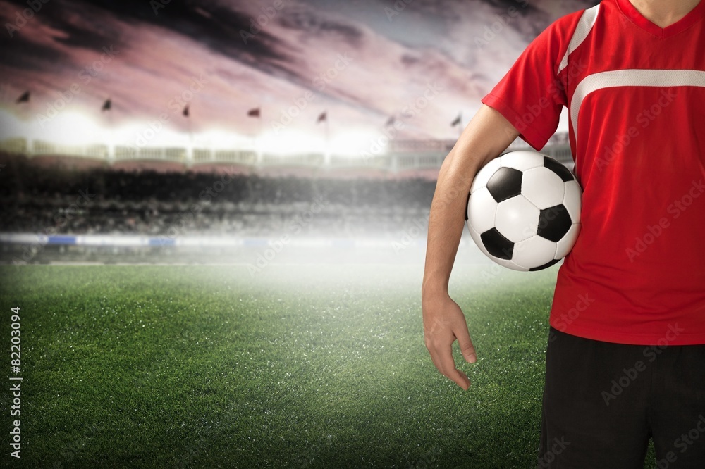 Soccer. Midsection of a soccer player holding a ball