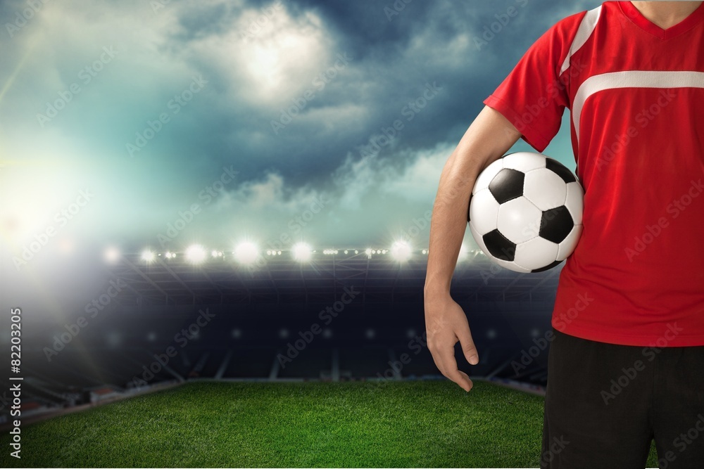 Soccer. Midsection of a soccer player holding a ball