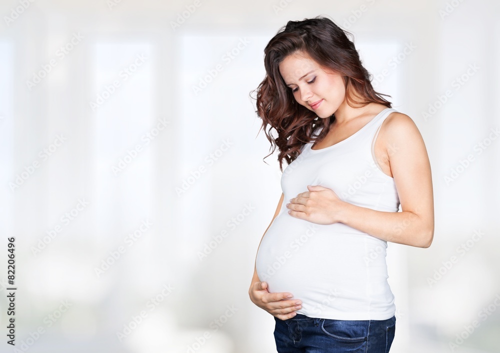 Abdomen. Pregnant woman caressing her belly