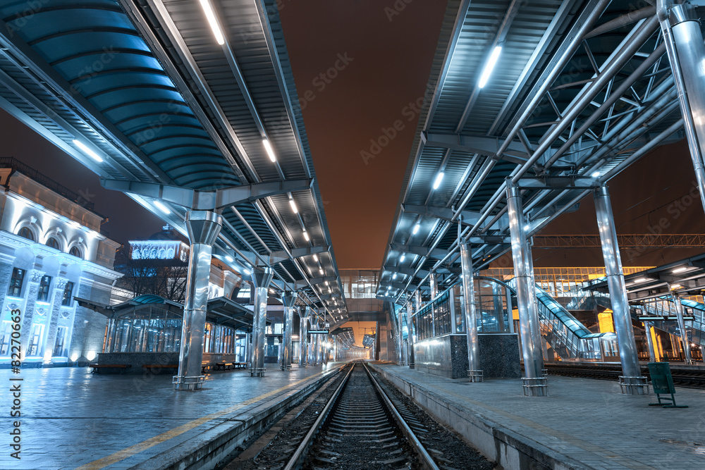 Railway station at night. Train platform in fog. Railroad