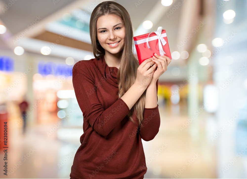 Gift. Attractive Young Woman with Red Gift Box