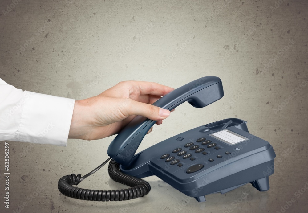 Telephone. Making a call, woman picking up phone receiver, stock