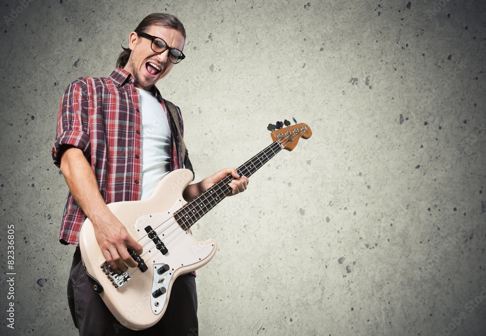 Art. Rock musician is playing electrical guitar.