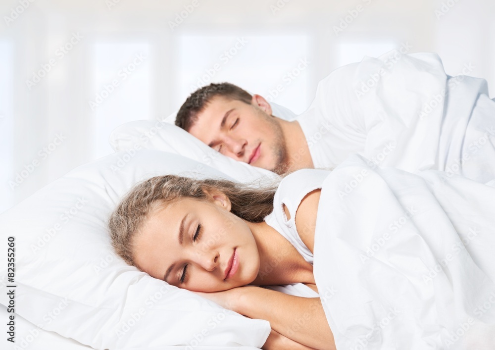 Adult. Romantic young couple sleeping in bed