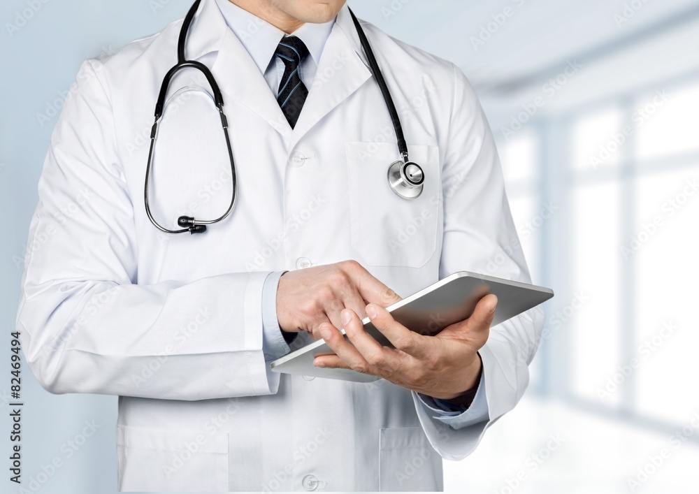 Doctor. Doctor using a digital tablet