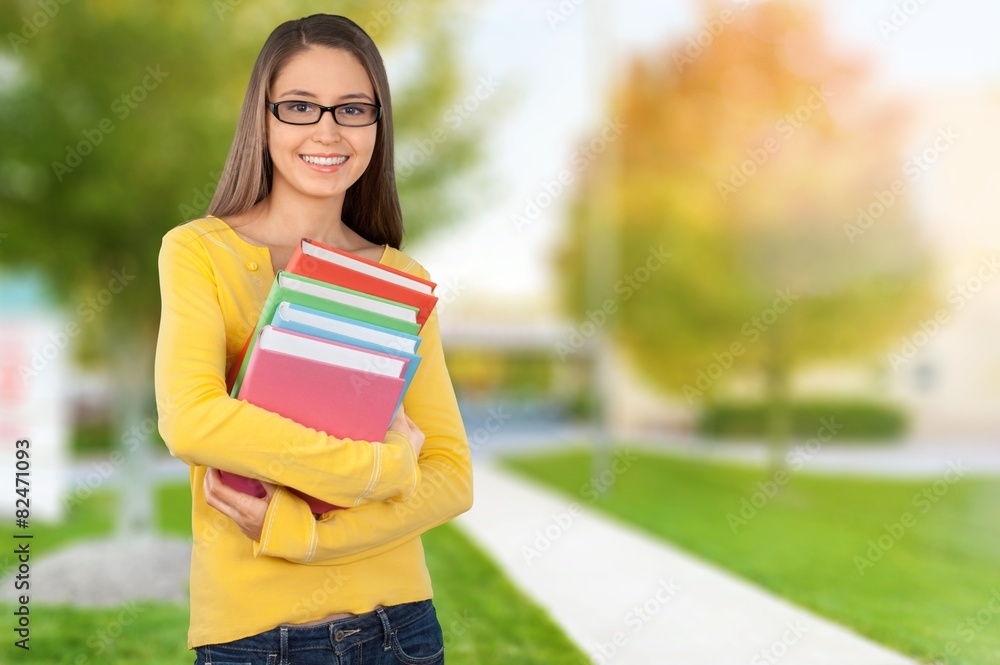 Student. Pretty Female Student Surrounded by Library Books