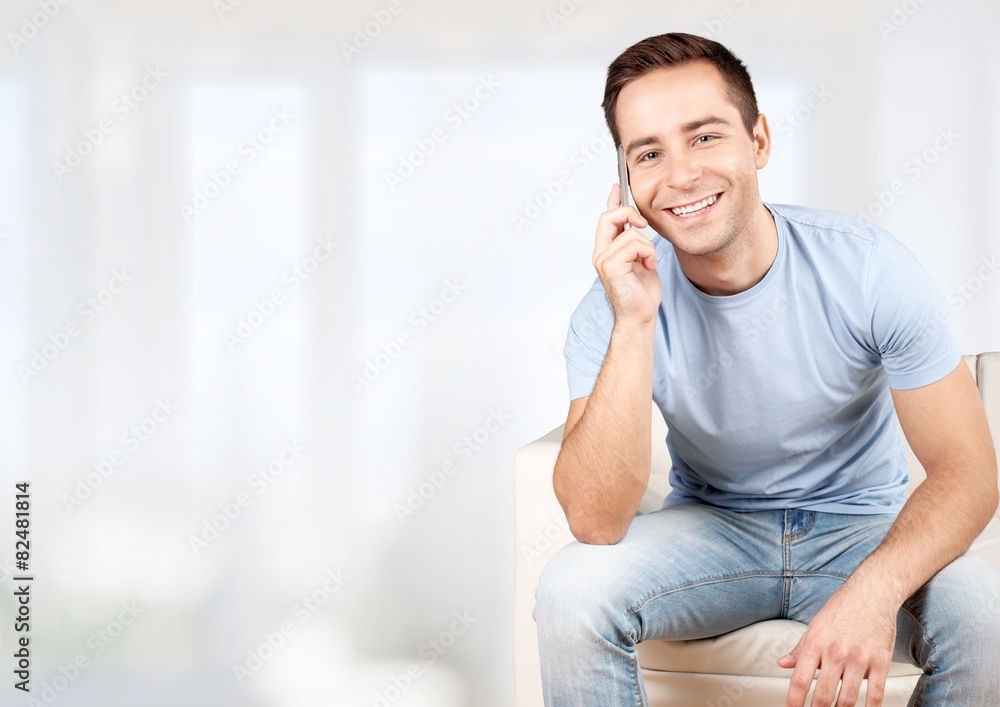 Phone. Portrait of a young man using a mobile phone