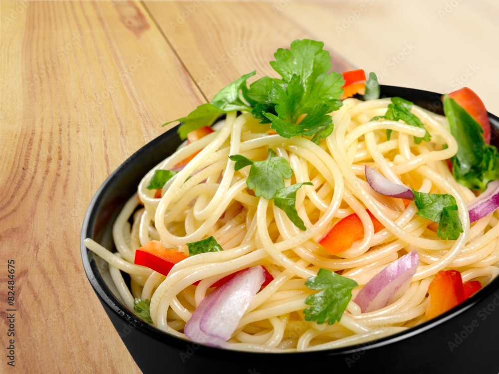 Spaghetti. Pasta in a white bowl with tomato sauce and fresh