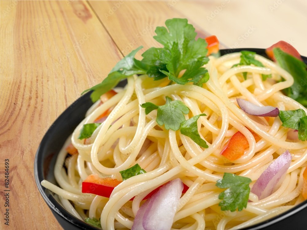 Spaghetti. Pasta in a white bowl with tomato sauce and fresh