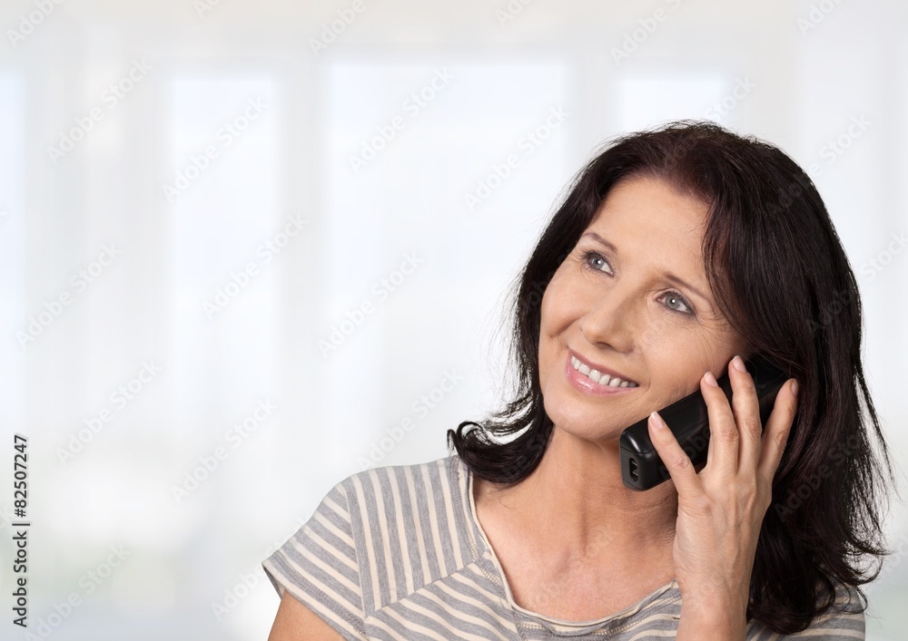 Telephone. Elderly woman talking on phone