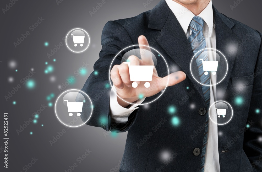 Retail. Business man pressing shopping cart icon