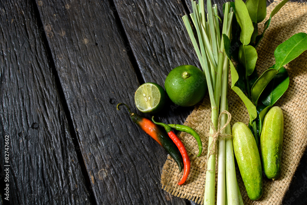 chili pepper with lime and Kaffir lime leaf on old wooden table