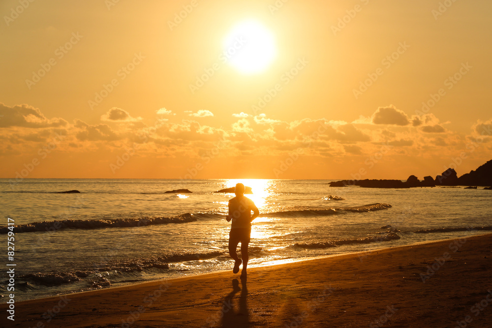 Silhouette of a fit runner at sunset