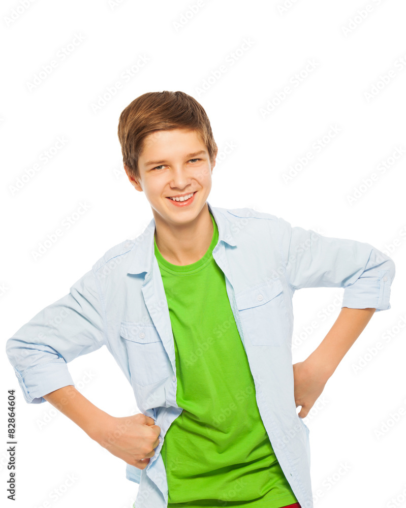 Cute young teen boy smiling with hands on waist 