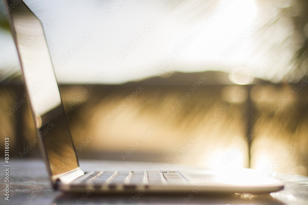 laptop on nature at sunrise