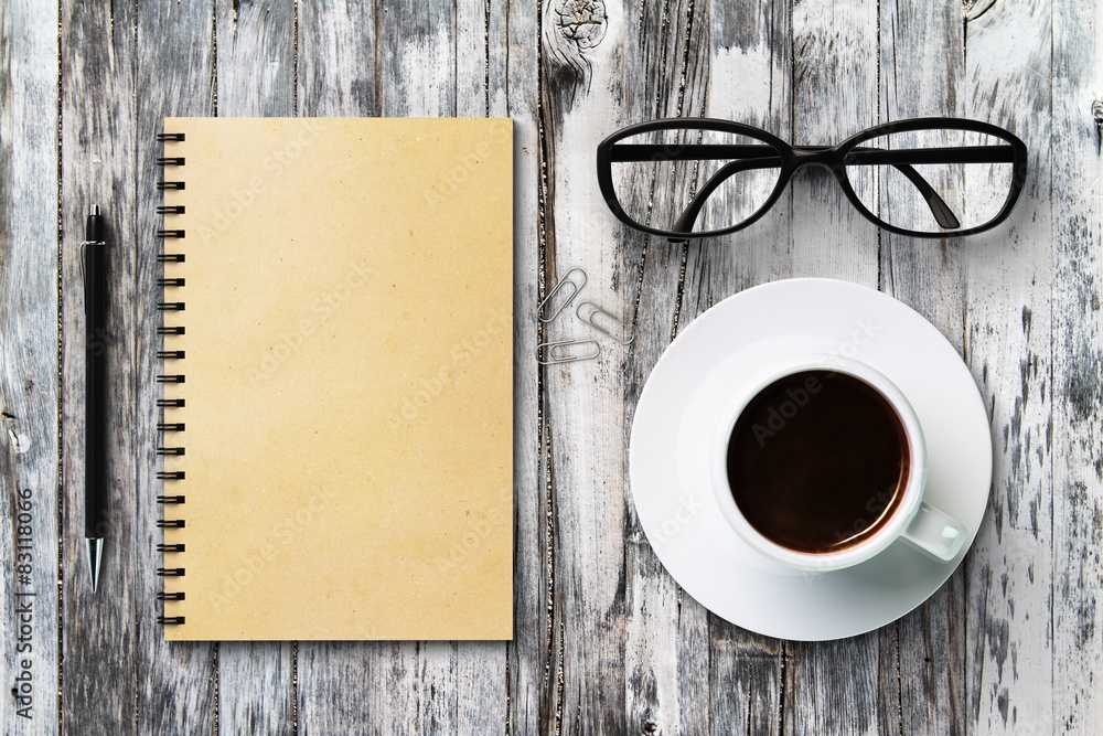 Blank diary and coffee cup on a vintage wooden table, mock up