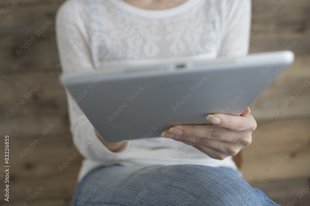 Woman sitting reading e-books