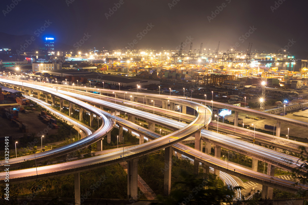 Illuminated and elevated expressway and cityscape at night