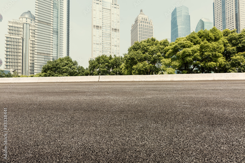 Asphalt road in front of the modern building， in Shanghai，china。