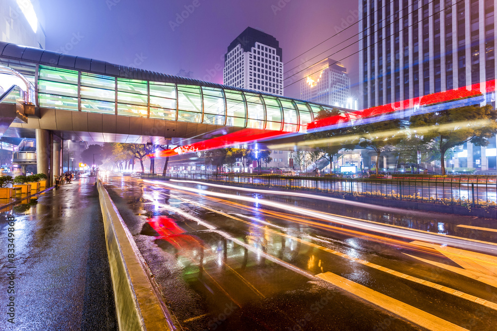 Traffic light trails in illuminated city