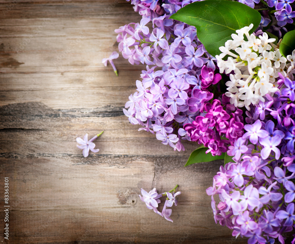 Lilac flowers bunch over wooden background