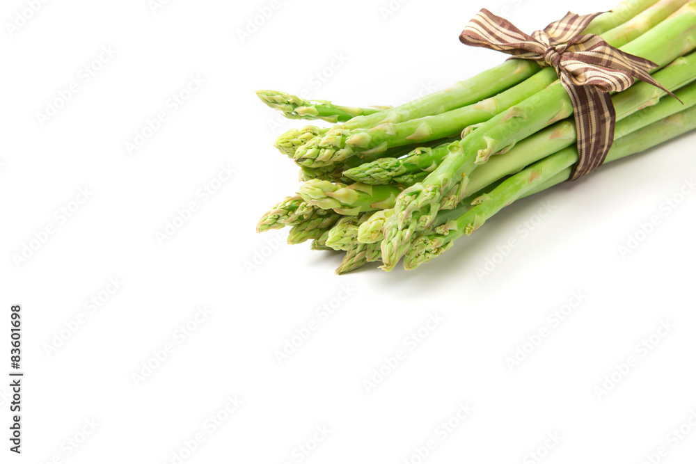 Asparagus bind with brown ribbon on white background