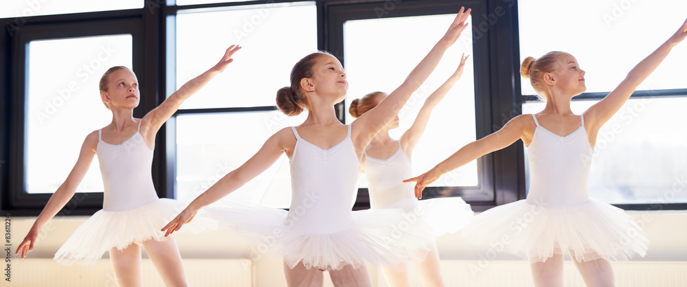 Young ballerinas practicing a choreographed dance