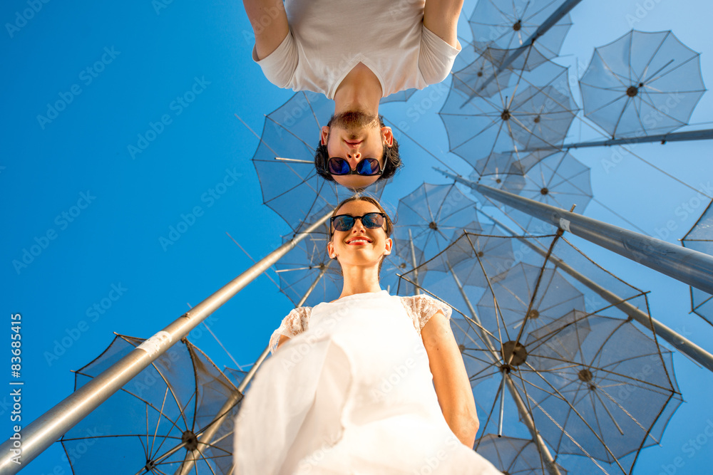 Portrait of Couple on the abstract background with umbrellas